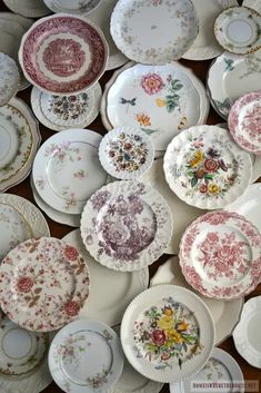 many plates with different designs on them are arranged in a pattern and one is empty