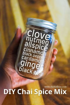 a person holding a jar with some type of spice in it that says clove nutmeg allspice cinnamon black pepper ginger ginger black tea