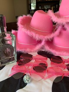 some pink hats and sunglasses on a table