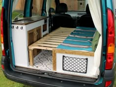 the back end of a van with a bed in it