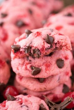 a pile of cookies with chocolate chips and cherries