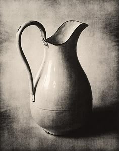 a black and white photo of a pitcher