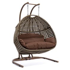 a hanging egg chair with brown cushions