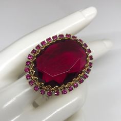 Badgley Mischka Ring With Massive Stone Surrounded By Fuchsia Crystals . If You Are Searching For A Statement Ring - This Is The One . Comes With A Tag Attached . Never Worn . In Very Good Condition . Oval Ruby Ring For Party, Oval Ruby Ring For Parties, Pink Gemstone Jewelry For Evening, Crystal Jeweled Party Rings, Ruby Party Ring, Elegant Crystal Rings For Evening, Elegant Faceted Ruby Ring For Formal Occasions, Pink Rings With Sparkling Stones For Formal Events, Elegant Evening Crystal Rings