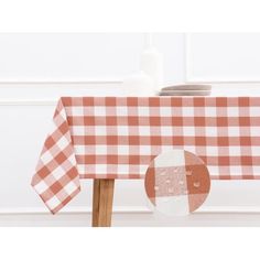 a red and white checkered tablecloth with plates on it