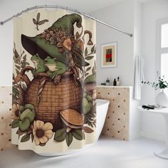 a bathroom with a shower curtain that has an image of a frog sitting on top of a basket