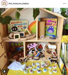 there are many books and toys on the shelf in this room with yellow table cloth