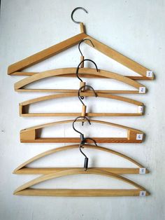 several wooden hangers with hooks hanging from them