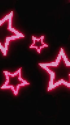 four red and white star shaped lights in the dark