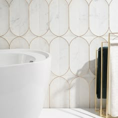 a white sink sitting next to a wall mounted faucet