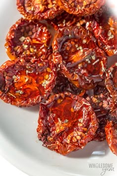 dried red peppers are on a white plate