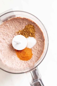 a blender filled with some kind of food on top of a white countertop