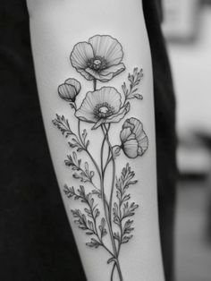 a black and white photo of flowers on the arm