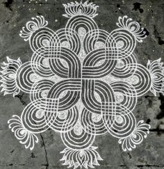 an intricately designed design on the ground in white and grey colors with black lines