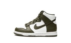 The Nike Dunk High PS “Cargo Khaki” is a two-tone, white and olive green colorway of the classic basketball shoe by Nike in preschool sizing.  Designed in a fall-friendly color palette, the “Cargo Khaki” is yet another versatile look for the Dunk High.  The shoe’s perforated toe, mid-panel, and collar appear in white leather.  Contrasting Cargo Khaki-colored overlays and Swoosh branding on both sides add a pop of color against the white base.  Branding appears in the form of olive green “Nike” a Olive Nike Dunks, Olive Green Sneakers, Olive Green Nike, Sneakers Box, Kobe Shoes, White Shoes Sneakers, Cargo Khaki, Nike Dunk High, Dunk High