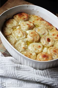 a casserole dish filled with food on top of a wooden table