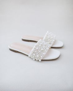 Classic satin slip on sandals adorned with allover pearls on the vamp for romantic, elegant and feminine look. The delicate pearl beads are placed to create a graceful classic style. Simple and easy wear for bridal wear, bridesmaids, holiday party, wedding parties, and any special occasions. DETAILS:UPPER: Synthetic upper and liningMATERIALS: Manmade outsoleHEEL HEIGHT: 0.4"Imported Materials Pearl Wedding Shoes Flats, Wedding Shoes With Pearls, Bridal Shoes Flats Sandals, Pearl Sandals Wedding, Flat Wedding Shoes For Bride, Bridal Beach Sandals, Brides Maid Shoes, Pearl Flats, Grad Shoes