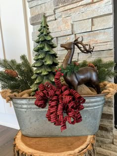 a metal tub filled with christmas decorations next to a fireplace