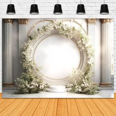 an empty white room with columns and flowers on the wall, in front of a round mirror