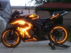 a black motorcycle with neon lights on it