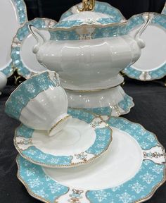 a white and blue china set with gold trimmings