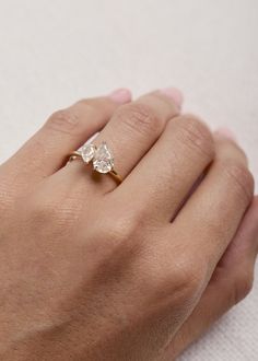 a woman's hand with a diamond ring on it