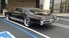 a black car parked in front of a building