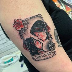 a woman with a tattoo on her arm and the words'the lovers'written in it