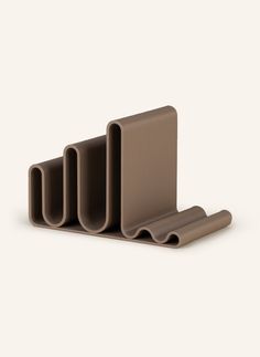 three pieces of brown plastic sitting on top of each other