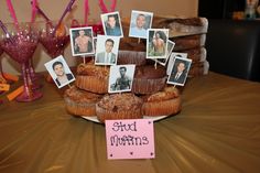 a table topped with lots of cupcakes and pictures