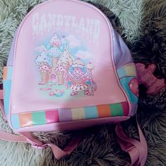 Dolls Kill Candyland Backpack. New. Never Used. Patent Vegan Leather. Candyland, King Kandy & His Castle, Pathway, & Lollipop Graphics. Adjustable Shoulder Straps. Approx. 9" W X 10.25" H X 6" D Cute Standard Backpack, Cute Pink Backpack For Everyday Use, Cute Multicolor Backpack For Gift, Trendy Backpack For Playtime, Playful Pink Backpack For Everyday Use, Purple Standard Backpack Bag As Gift, Purple Standard Backpack Bags As Gift, Cute Backpack For Playtime, Cute Backpack With Adjustable Strap