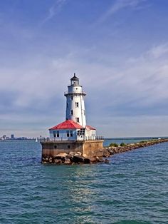 a light house sitting on top of a pier next to the ocean