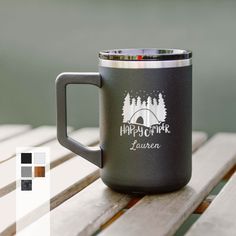 a camper mug sitting on top of a wooden table