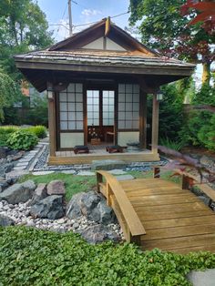 a wooden bench sitting in front of a gazebo