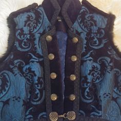 Mens Metallic Blue Brocade Vest. Made In Usa. Black Velvet Trim, Silver Engraved Buttons And Clasp, Black Rabbit Fur Trim On Shoulder Openings, Military Style Shoulder Straps. Vest Has Front Clasp, Cropped In Front, And Two Tails In Back. Velvet Trim, Rabbit Fur, Metallic Blue, Toy Soldiers, Trim Color, Fur Trim, Military Fashion, Black Velvet, Blue Black