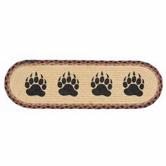 a rug with three paws on it, and four smaller paws in the bottom right corner