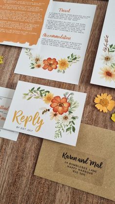 the wedding stationery is laid out on a wooden table