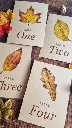 four cards with autumn leaves on them that say table, two, three and four