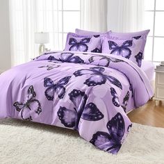 a bed with purple butterflies on it