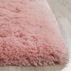 a pink shaggy rug is on the floor