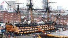 an old pirate ship is docked in the harbor