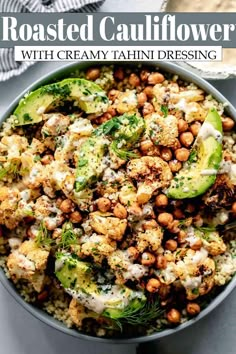 roasted cauliflower with creamy tahini dressing in a bowl on top of a table