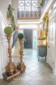 an entry way decorated for christmas with angel decorations