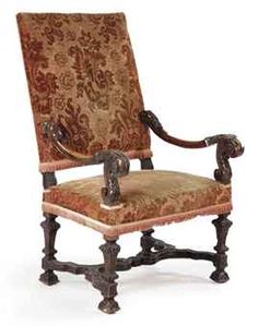 an old fashioned chair with ornate upholstered back and arm rests against a white background