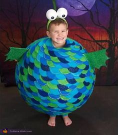 a young boy in a costume made to look like a fish