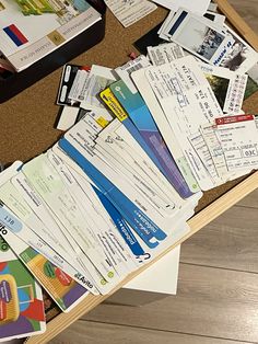 a pile of papers and tickets on a table