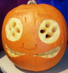 a carved pumpkin with two holes in it's face