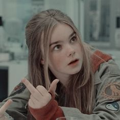 a girl pointing at something with her finger