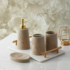 a bathroom set with soap dispenser, toothbrush holder and two cups