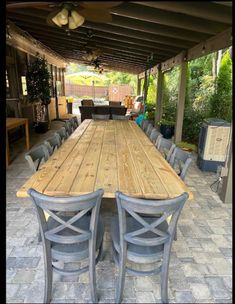 an outdoor dining table with six chairs around it